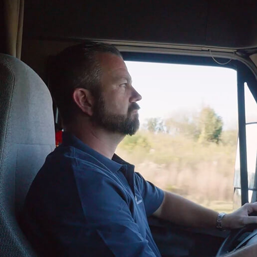 Purdy Bros truck driver actively driving semi truck